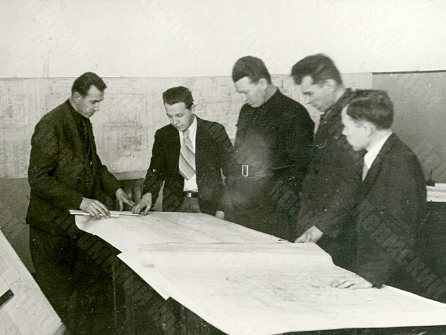 Director of the Stalin Molotov Plant No. 19 A.G. Soldatov (center) among the workers of this enterprise at a meeting to approve the design of new machine tools for the plant